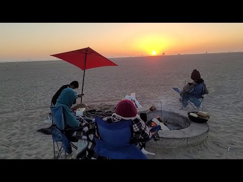 Stunning sunset beach bonfire BBQ at Huntington Beach in Orange County California USA