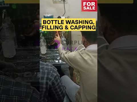 Bottle washing, filling and capping machine - video