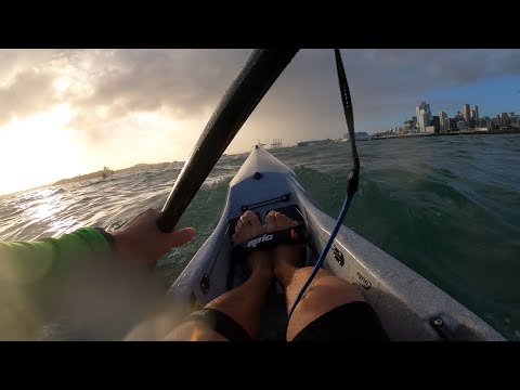 V7 Epic surfski in Auckland. Beautiful dramatic sky.