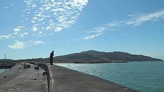 Catching a fish on Holyhead Breakwater Anglesey Ynys Mon Wales UK