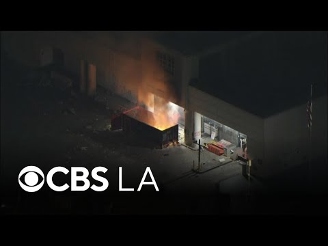 Small group lights dumpster fire outside federal building in downtown LA