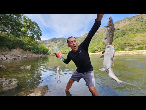 Don Jose catches a large catfish with a piece