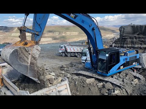 Blue Caterpillar 345C Excavator Loading Trucks