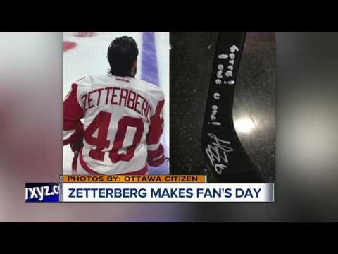 Henrik Zetterberg spills fan's beer, then signs a stick for him