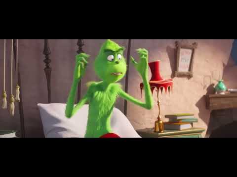Trailer frame of the Grinch in his Santa disguise preparing the heist