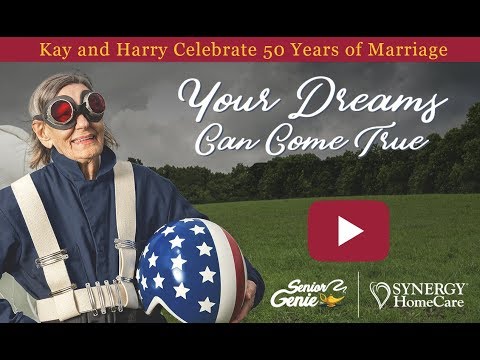 Senior woman in wheelchair enjoying time in the park with caregiver