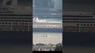 Paddlewheeler looks up to cruise ship in Vancouver