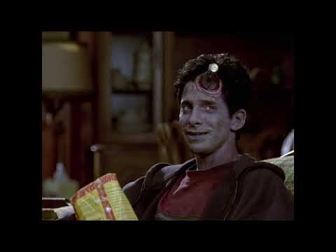 Idle Hands 1999 official trailer frame: the possessed right hand lunging during the high-school dance