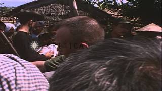 Navy officers of USS Hornett County doing medical check-up in a Vietnam village HD Stock Footage