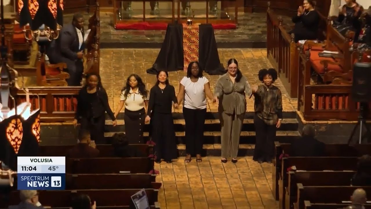 students performing indoors at front of chapel