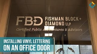 Installation Process of Vinyl Lettering on a Glass Door