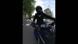 Woman on bicycle falls after crossing red light in front of motorcycle in Rotterdam, Netherlands