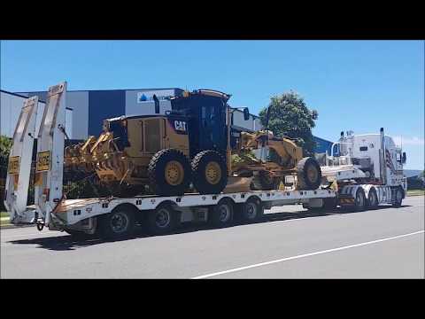 Caterpillar 140M Grader Departure from Depot on Kenworth Quad Float