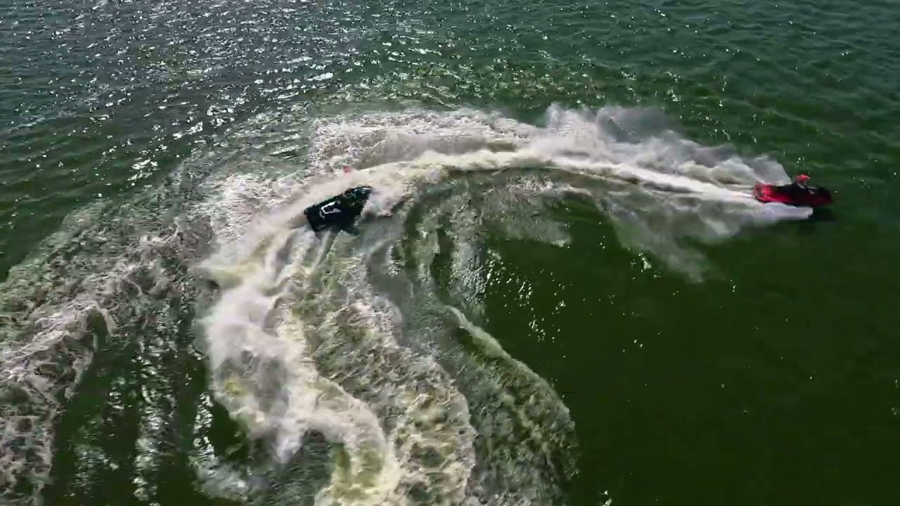 Aerial FPV drone shot over jet skis on open water — Propelling Views Tampa Bay Florida