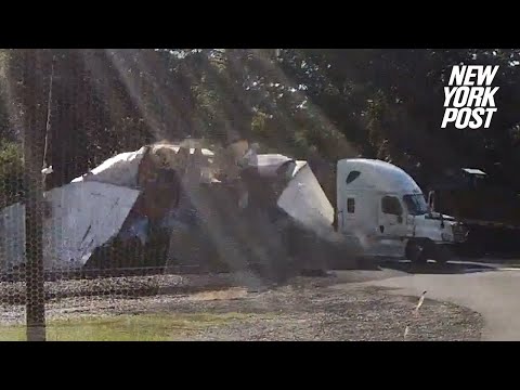 Speeding train slices tractor-trailer in half