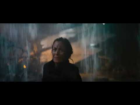 Trailer frame: Rita Vrataski steps through smoke; metallic hits punctuate her entrance