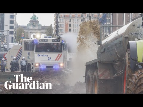 Belgian farmers spray manure towards police who respond with water cannon