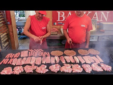 Best of Balkans Street Food. Mixed Meat Roasted on Huge Grills. Street Food Festival seen  in Italy