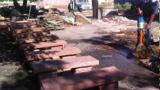 Broomfield landscape contractor Drilling holes for a bubbling rock water feature