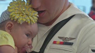 Sailor meets baby daughter for the first time at Buffalo Airport