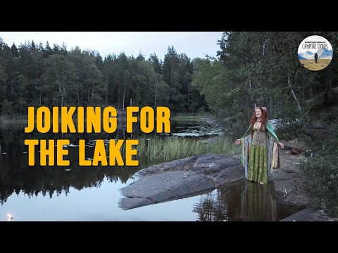 Ellen Molnia joiking by a lake in Sweden