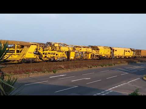 Trains. Freightliner Class 66 locos top and tail a track maintenance train through Starcross.