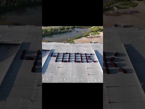 Giga Texas 400k Model Ys! To celebrate, lit up the parking garage with an all‑red Model Y display.