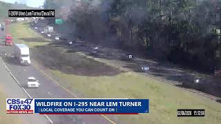 Firefighters work to extinguish wildfire on I-295 near Lem Turner Road