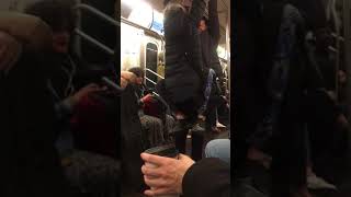 Subway creatures  a couple hanging from subway rails man wraps legs on woman