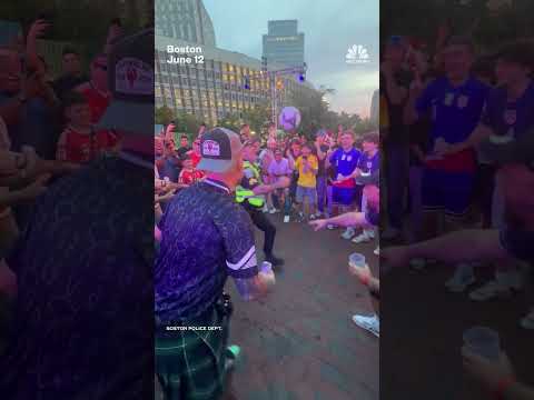 Police officer juggles soccer ball with World Cup fans