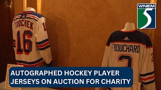Autographed hockey player jerseys on auction for charity