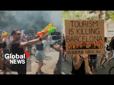 Barcelona locals shoot water at visitors in protests against mass tourism
