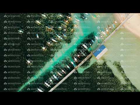 Pier with boats in the sea, aerial view. General Luna, Siargao island.