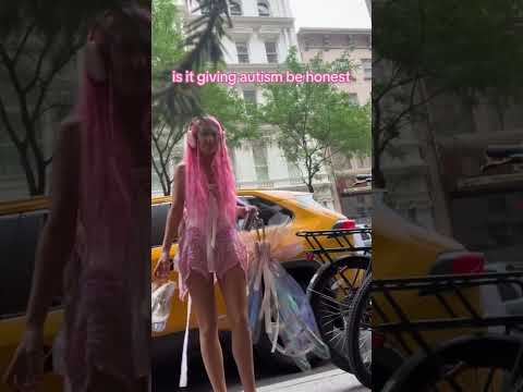 standing overwhemled on the streets of NY in a pink wig, pink wings and stripper heels blasting fnaf