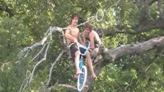 Kyle "Boss Hog" rides a bike out of tree