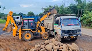 Jcb Loading stone in a Tata 2523c