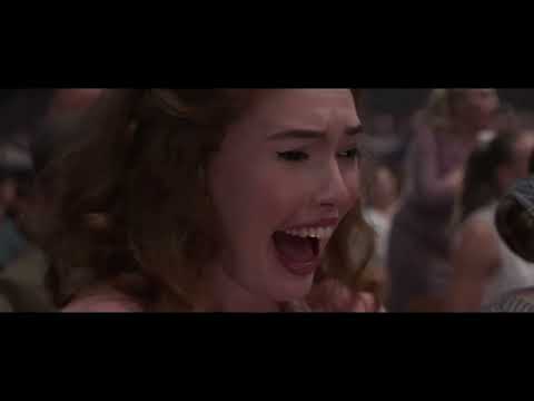ELVIS trailer frame: close on Elvis at a piano with orchestra lights behind, foreshadowing the finale