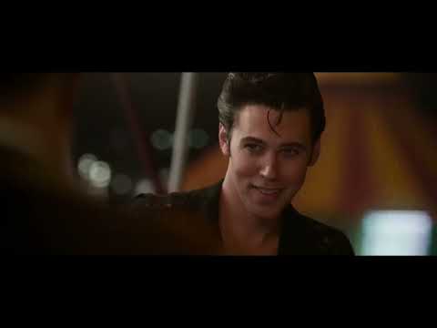 ELVIS official trailer still: stage lights and silhouette of Austin Butler as Elvis in mid-gesture