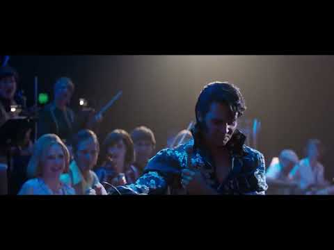 ELVIS trailer frame: brass, strings, and crowd roar in a Vegas showroom montage