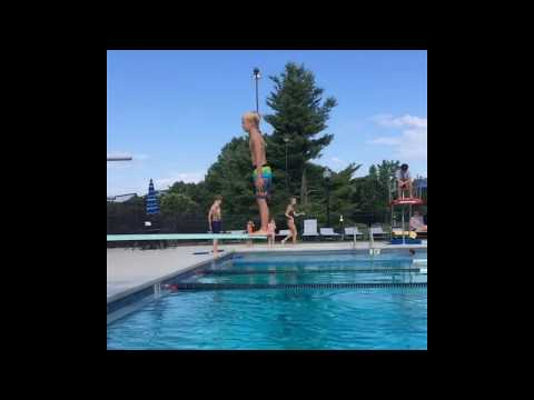 Kid tried doing a backflip on a diving board but doesn’t make it to the water.