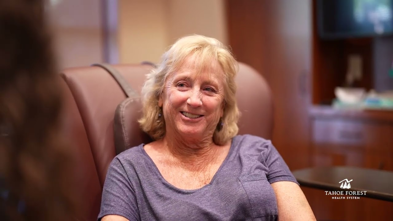 Woman sitting in a chair smiling