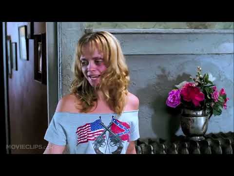 Trailer frame focusing on a dimly lit juke joint stage with guitar amp and mic