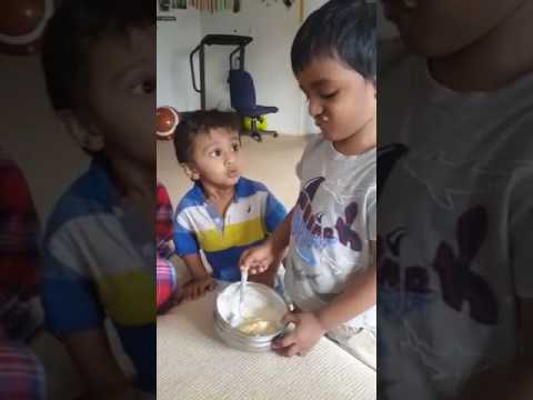 Brothers sharing ice cream