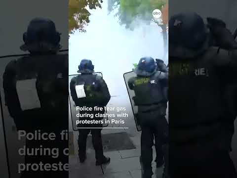 Police fire tear gas during clashes with protesters in Paris
