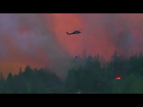 Raging wildfires destroy Washington town, roar through California, Oregon