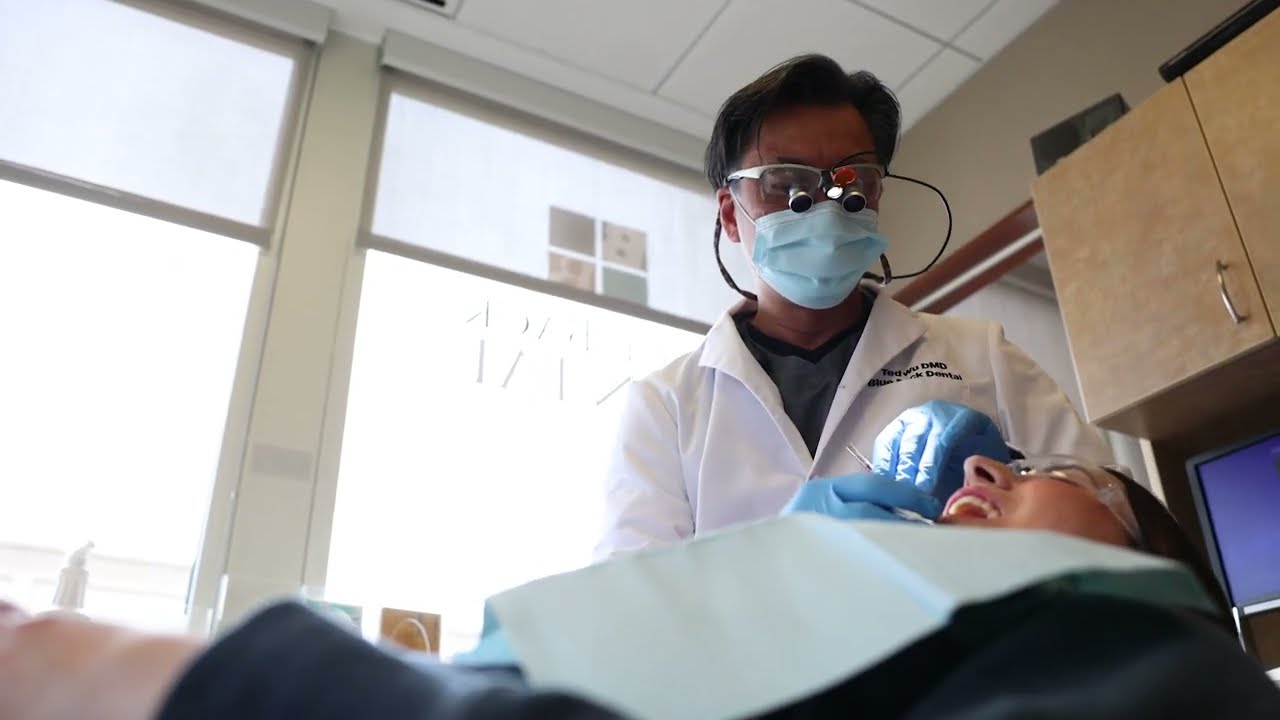 Close up of Dovtor Wu treating a dental patient