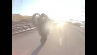 FPV drone flying under motorcycle wheelie