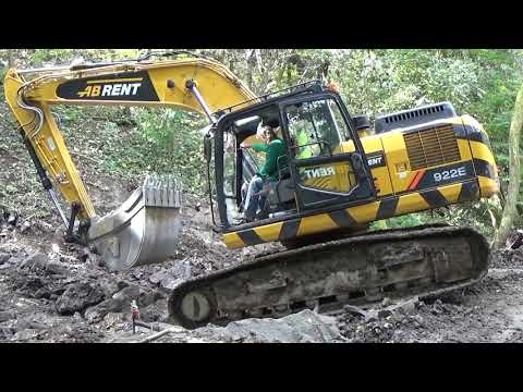 Bagr LiuGong 922E v náročném terénu. Pásové rýpadlo přejíždí potok, oprava kanalizace Olomučany.