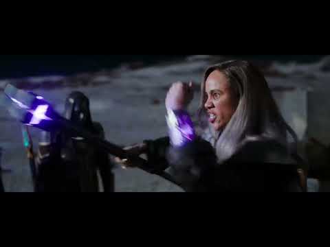 End credits style frame from The Marvels trailer with logo and cosmic background