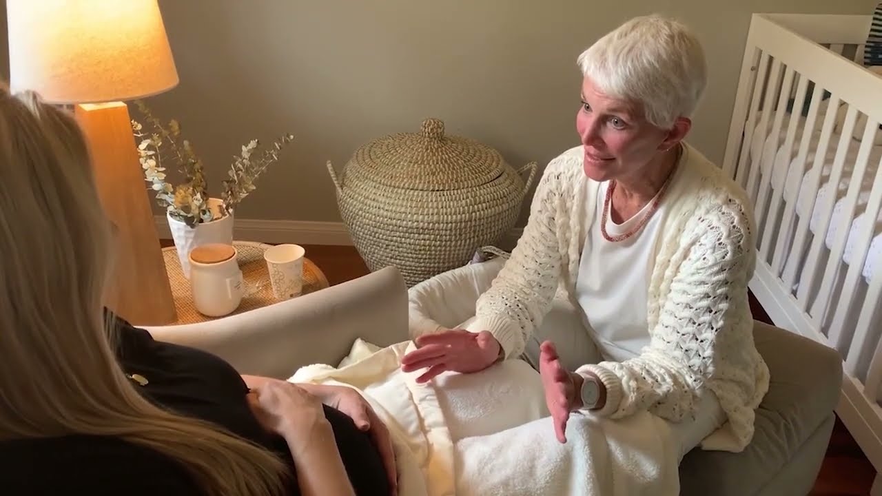 Lactation expert assisting a new mother at home